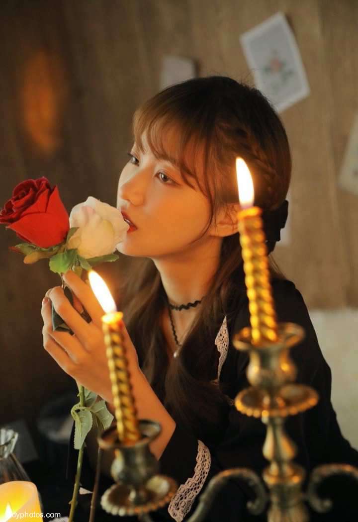 The beautiful and lovely girl in the candlelight is quiet, elegant and charming - 2